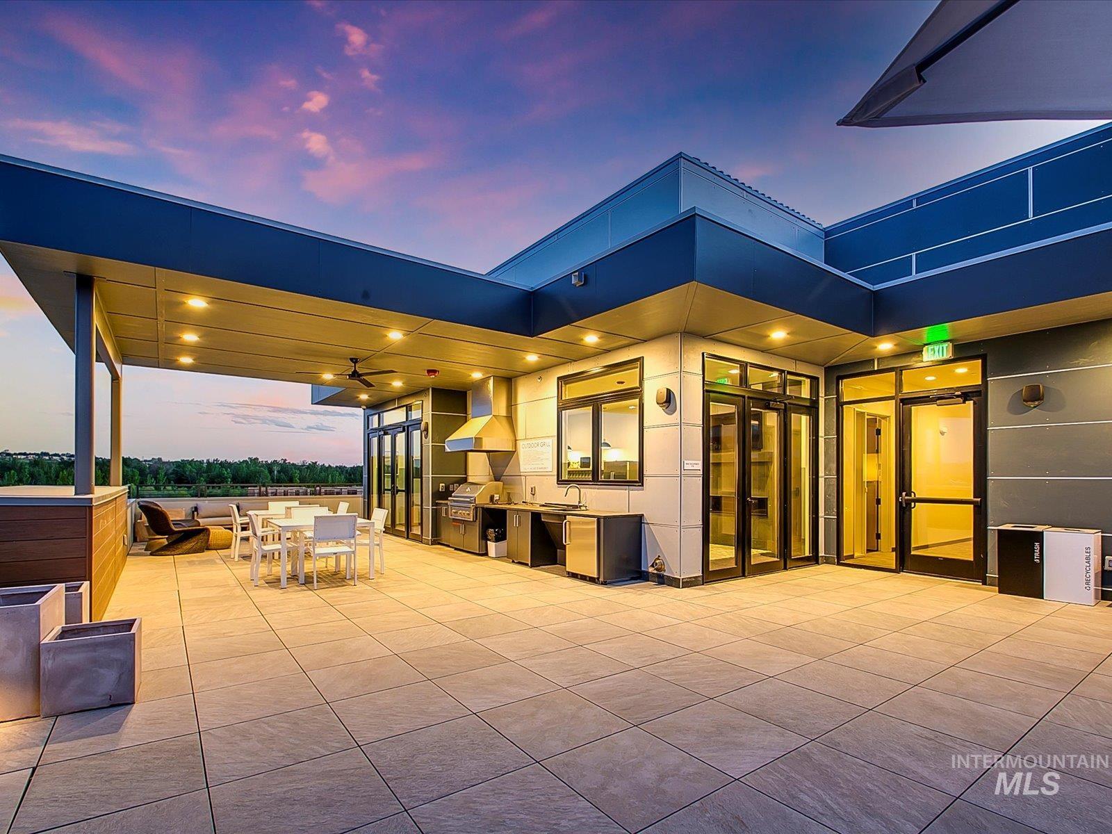 Patio terrace at dusk featuring exterior kitchen, a patio, and outdoor dining space