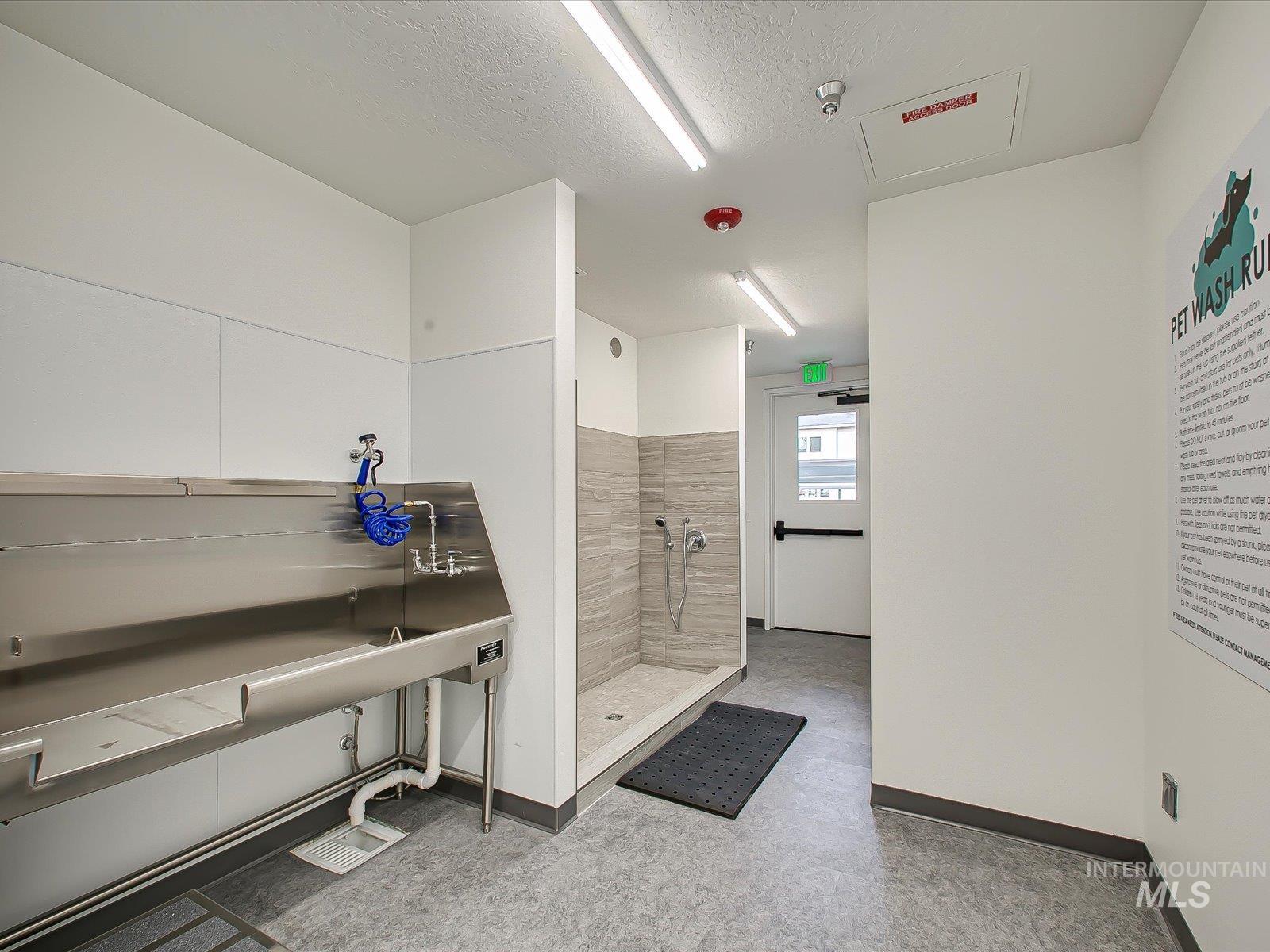 Full bath with a shower stall and a textured ceiling