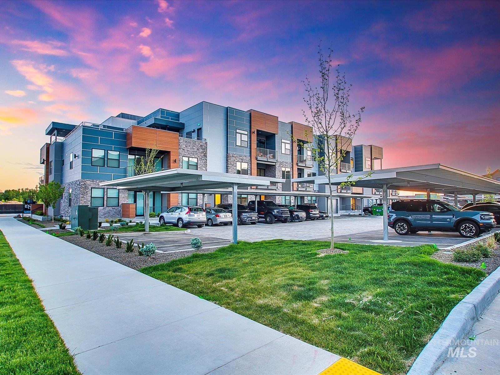View of apartment building / complex with covered parking