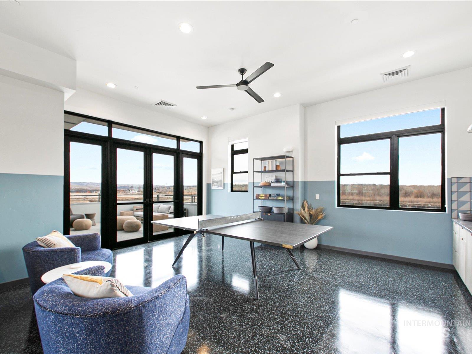Recreation room with healthy amount of natural light, ceiling fan, and recessed lighting