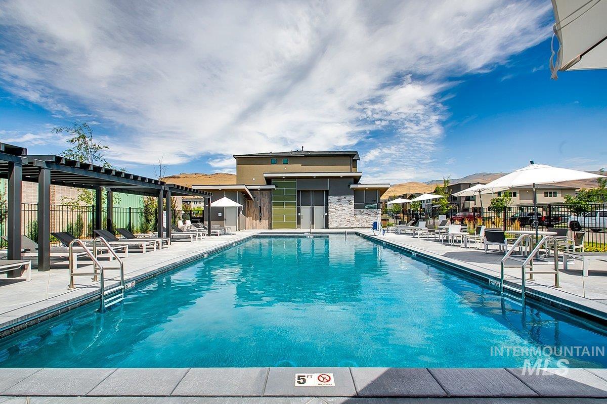 Community pool featuring a patio and a pergola