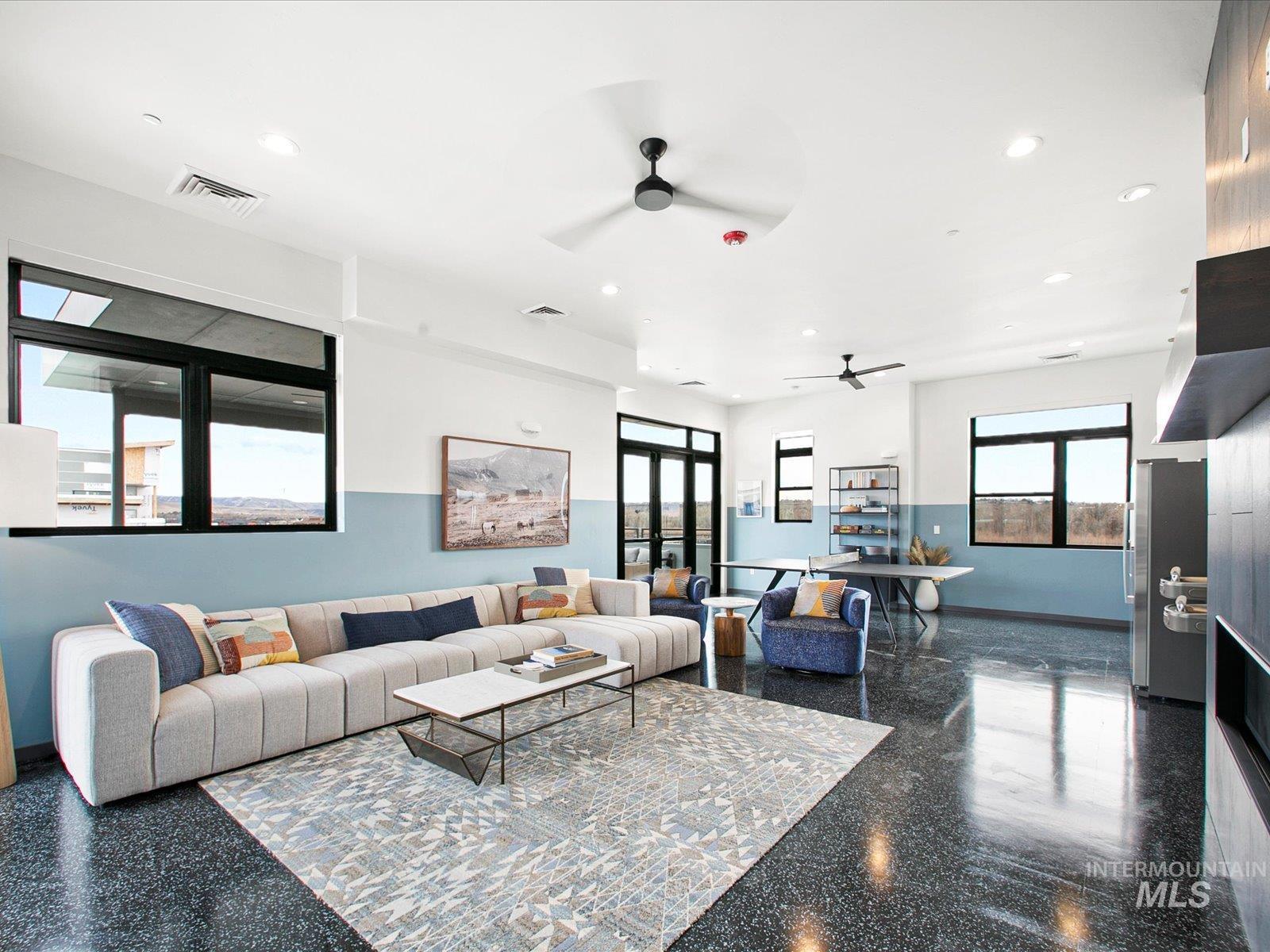 Living area with recessed lighting and a ceiling fan