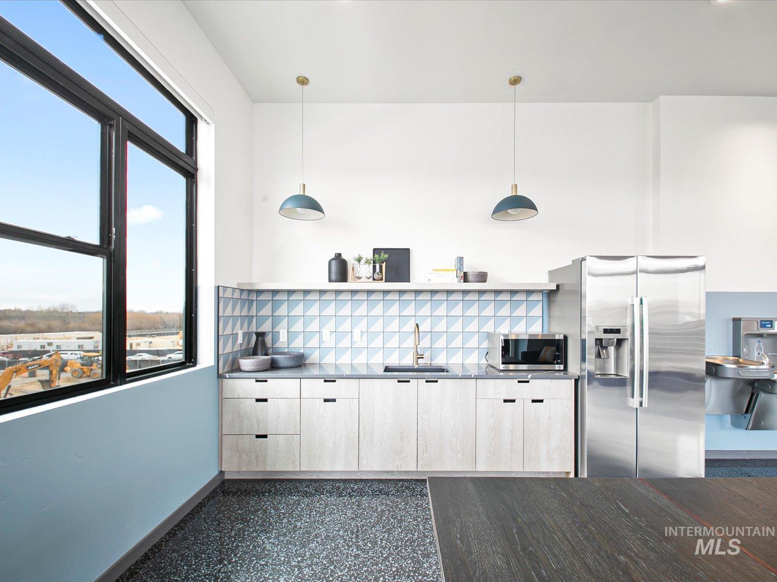 Kitchen featuring open shelves, stainless steel appliances, pendant lighting, and tasteful backsplash