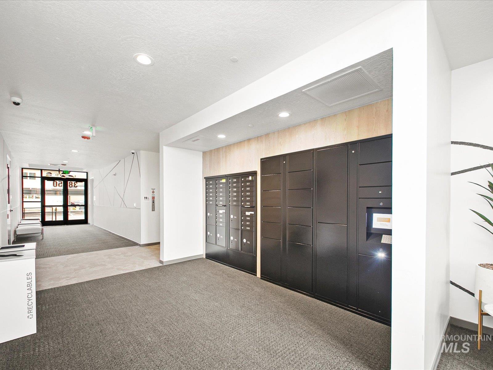 Surrounding community with mail area, a textured ceiling, and recessed lighting