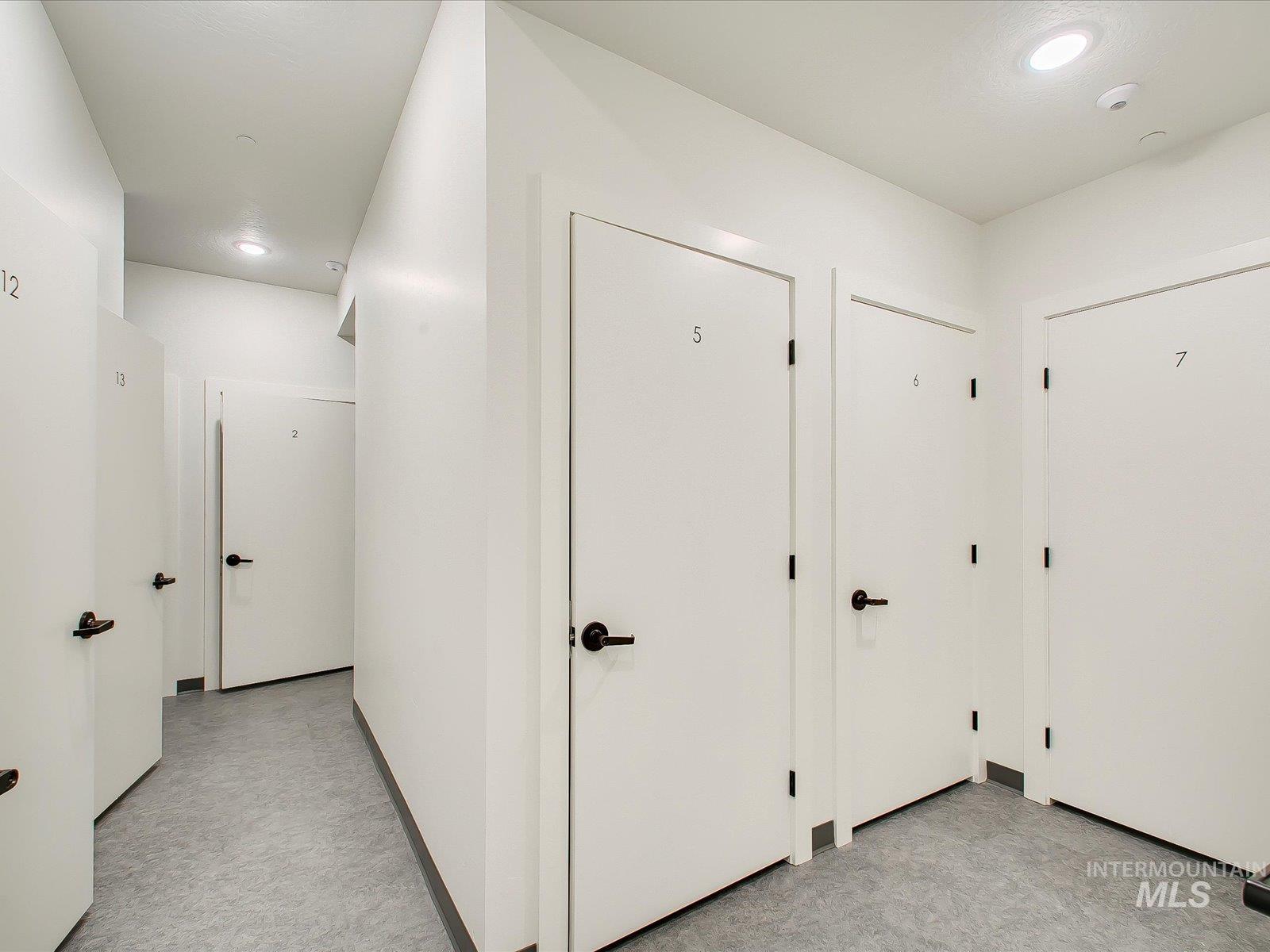 Hallway featuring recessed lighting and light flooring