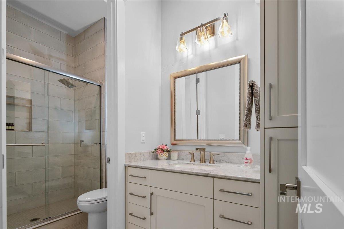 Full bath featuring vanity and a shower stall