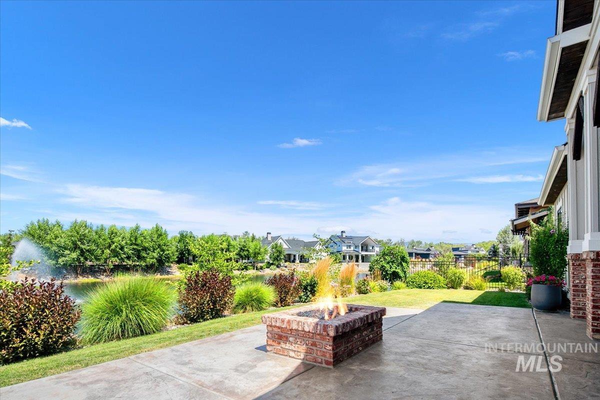 View of patio / terrace with a fire pit and a residential view