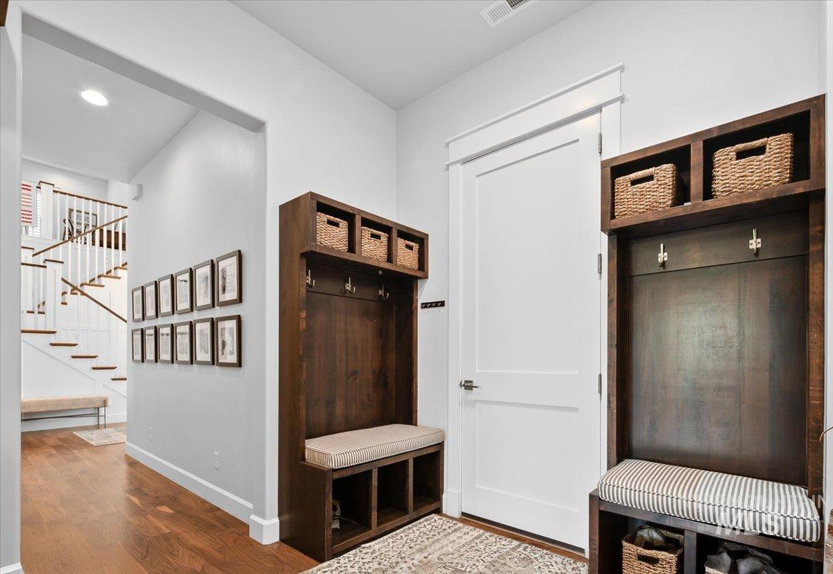 Mudroom featuring wood finished floors and baseboards