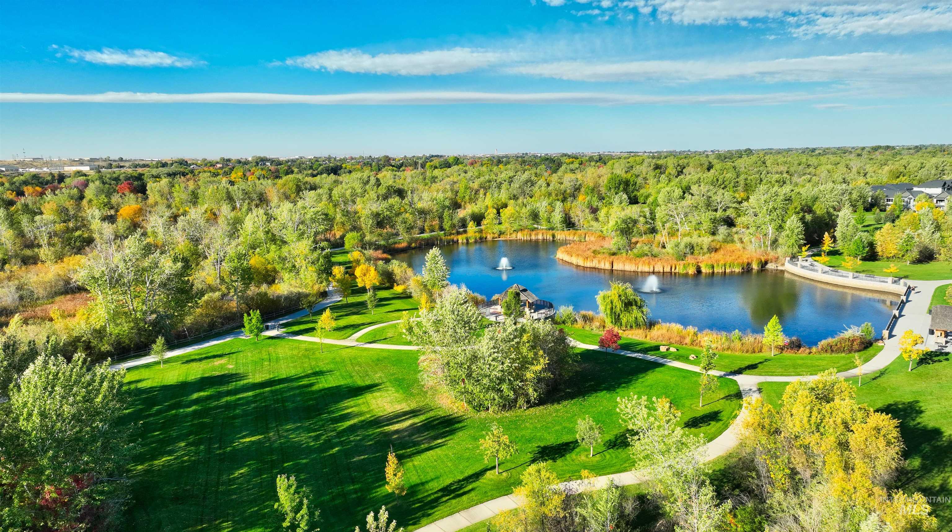 Drone / aerial view of a heavily wooded area and a large body of water