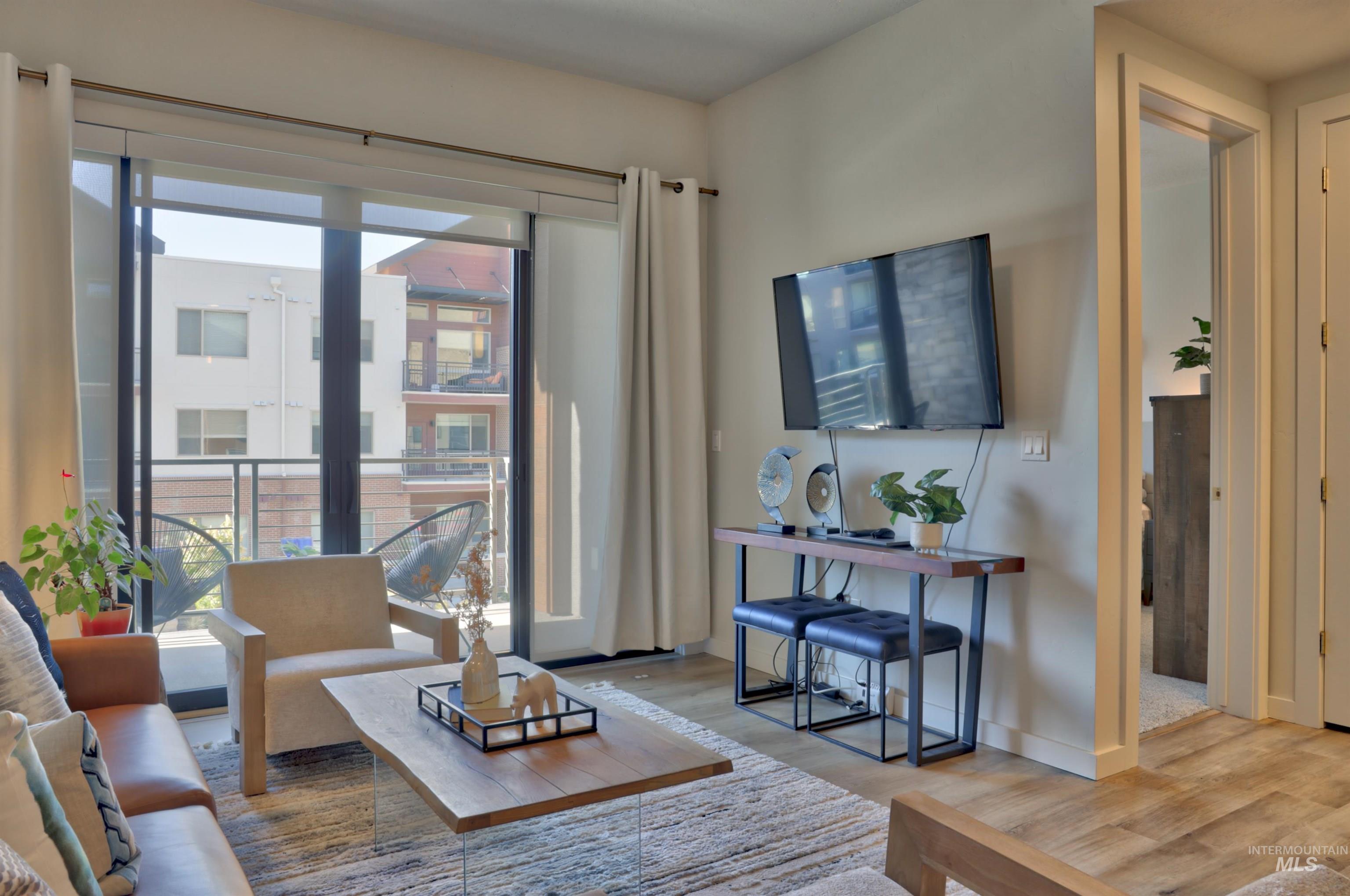 Living area with wood finished floors and baseboards