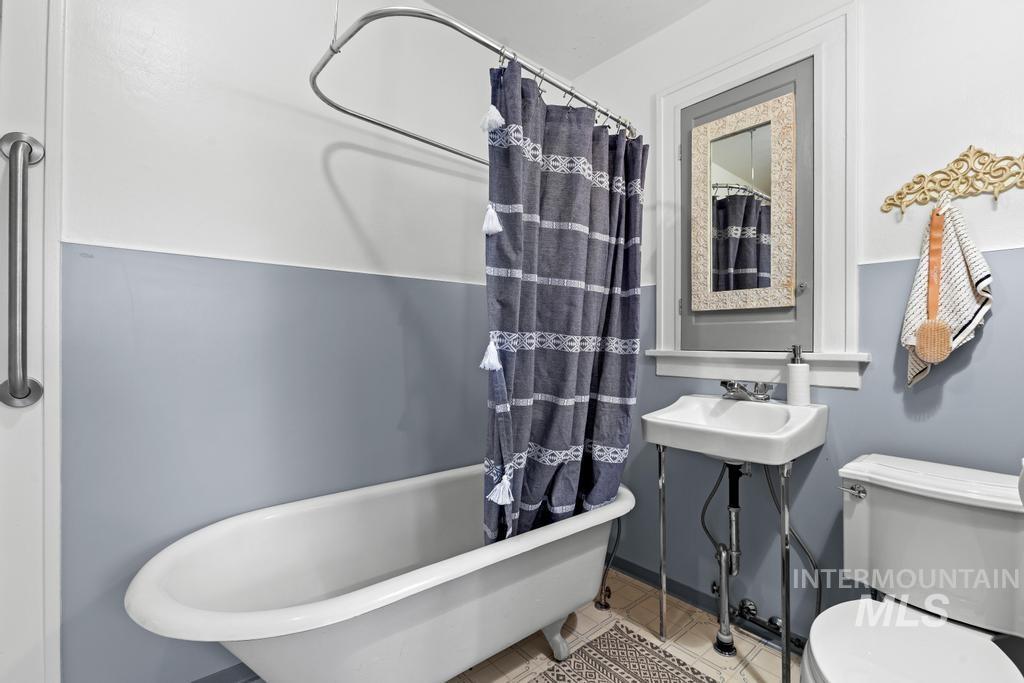 Bathroom featuring toilet and tile patterned flooring