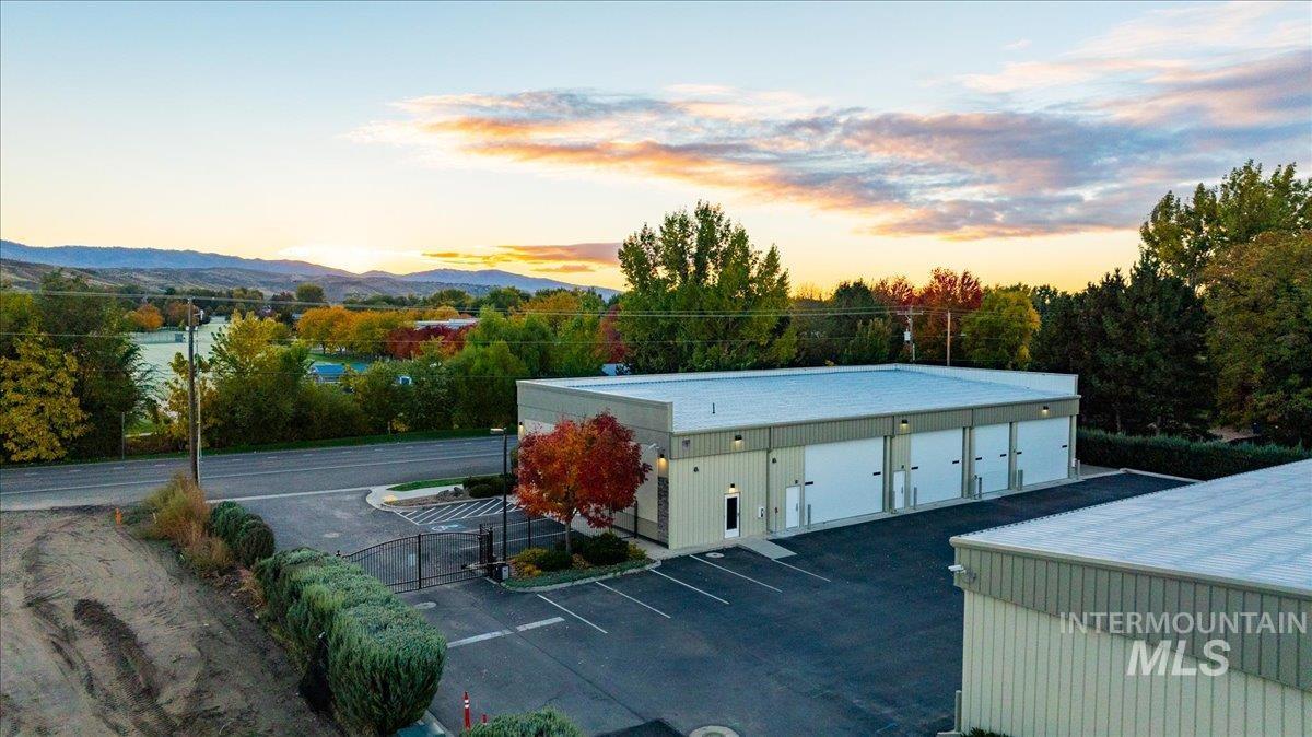 Property at dusk featuring uncovered parking