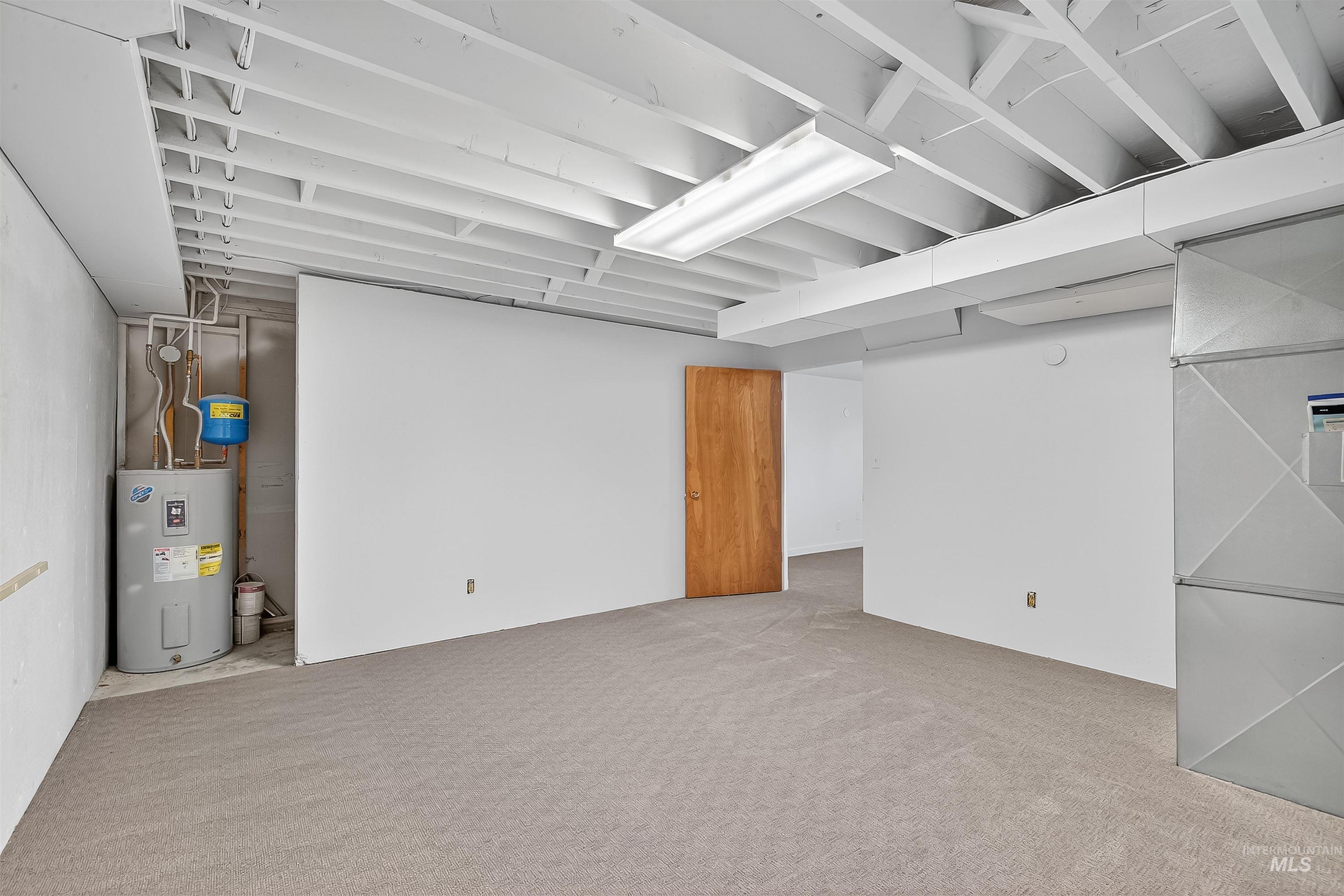 Finished below grade area with water heater and carpet flooring