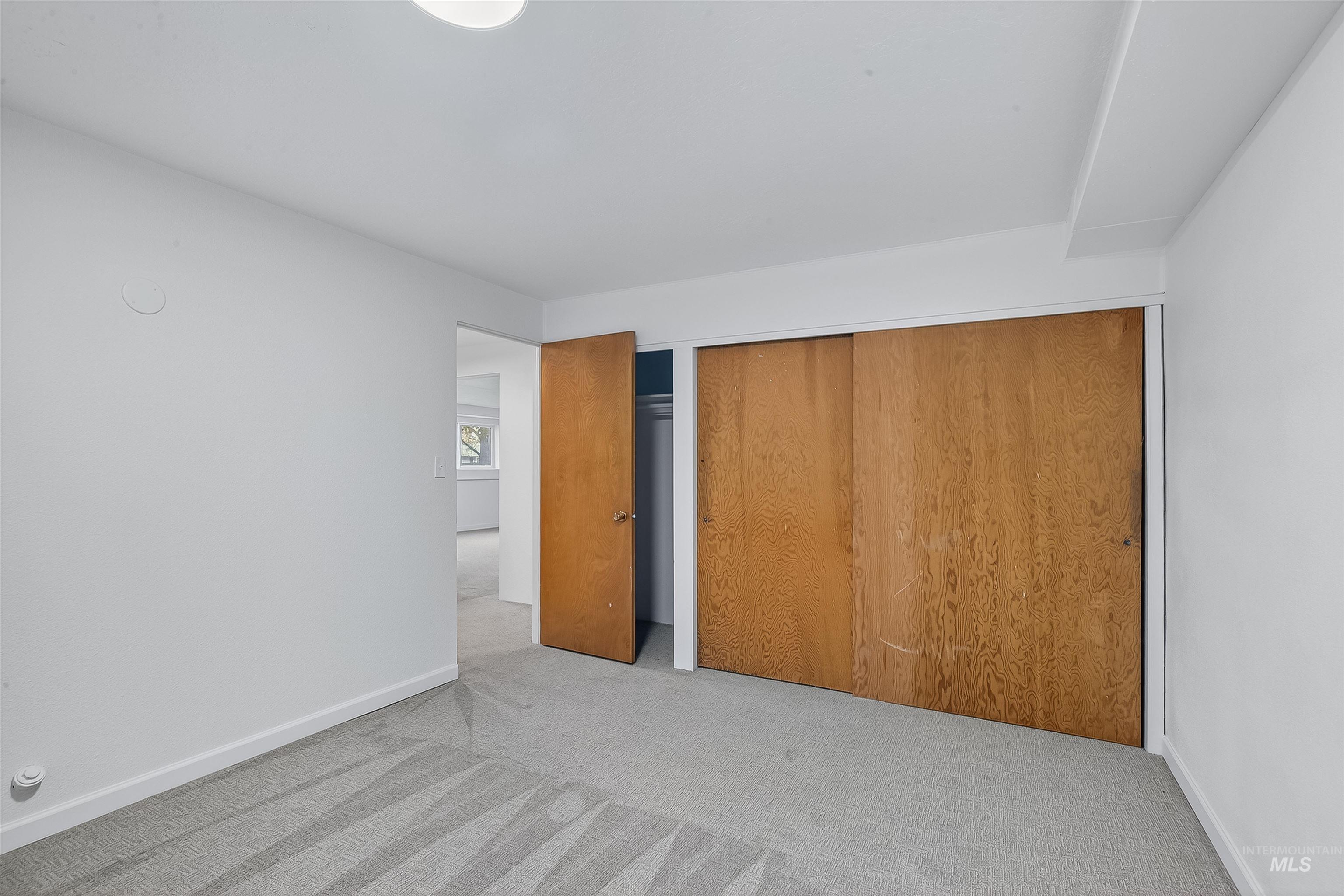 Unfurnished bedroom with carpet and a closet