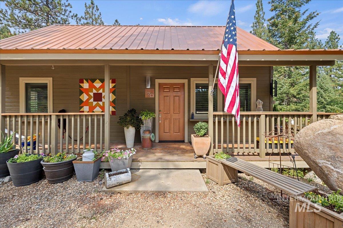 Property entrance featuring a metal roof and covered porch
