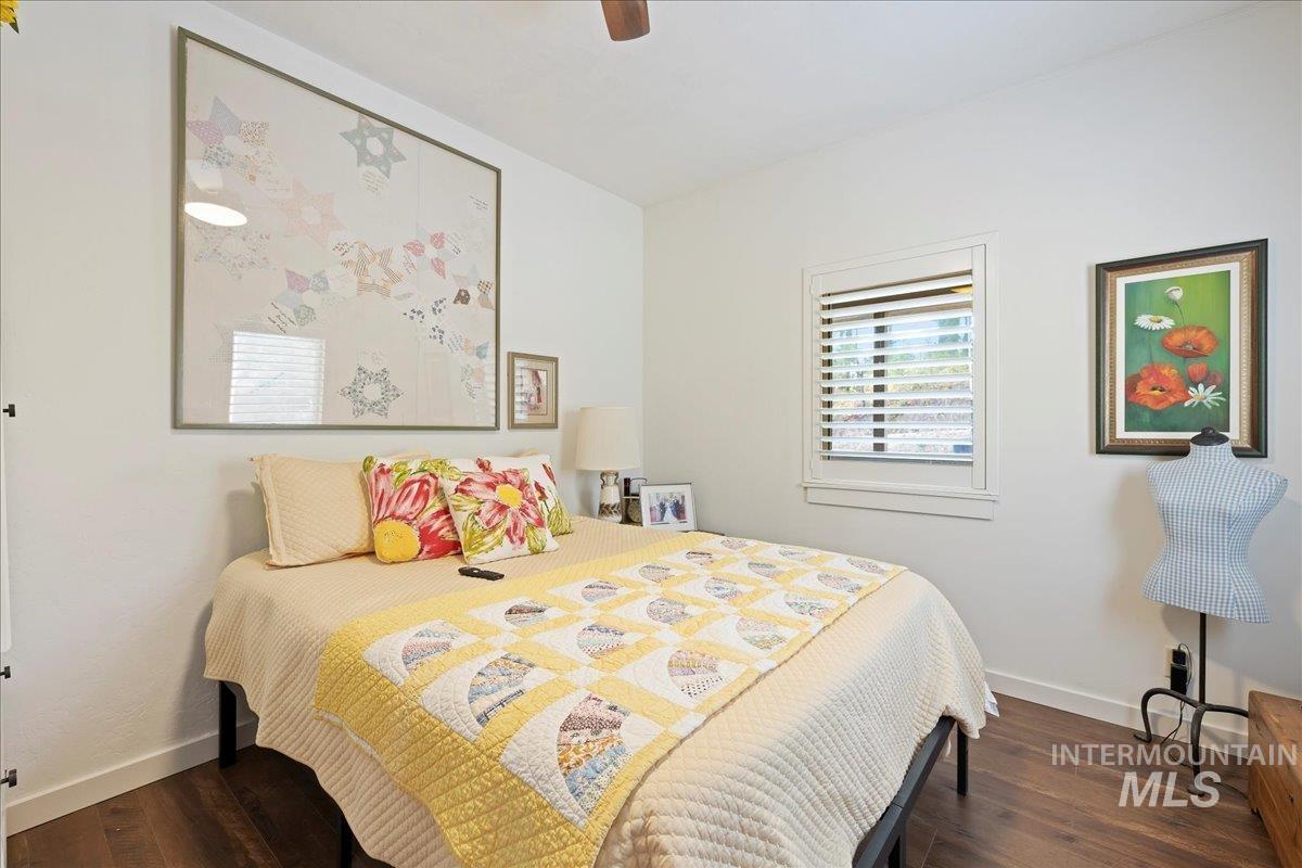 Bedroom featuring dark wood-style floors and ceiling fan