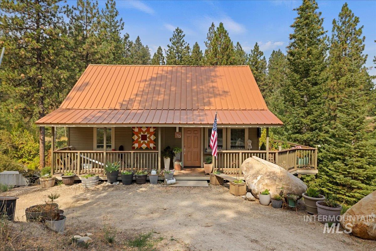 Rustic home with covered porch and a metal roof