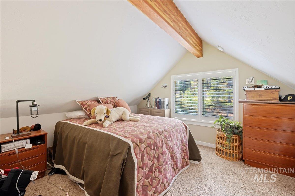 Bedroom featuring light colored carpet and baseboards