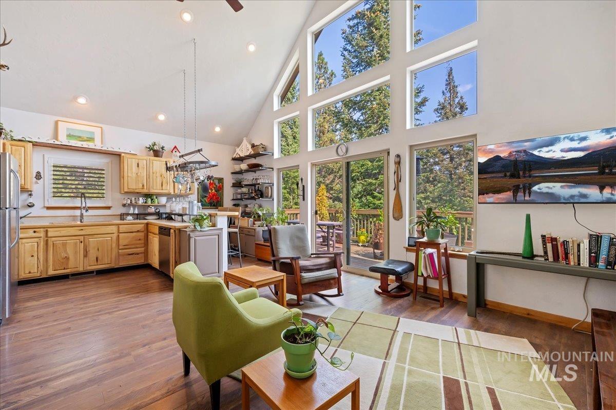 Kitchen featuring high vaulted ceiling, light brown cabinetry, dark wood-style floors, recessed lighting, and light countertops