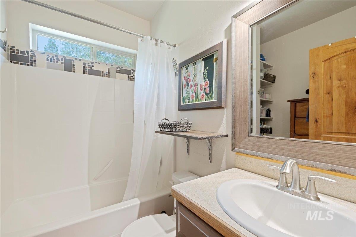 Bathroom with shower / bath combo with shower curtain and vanity
