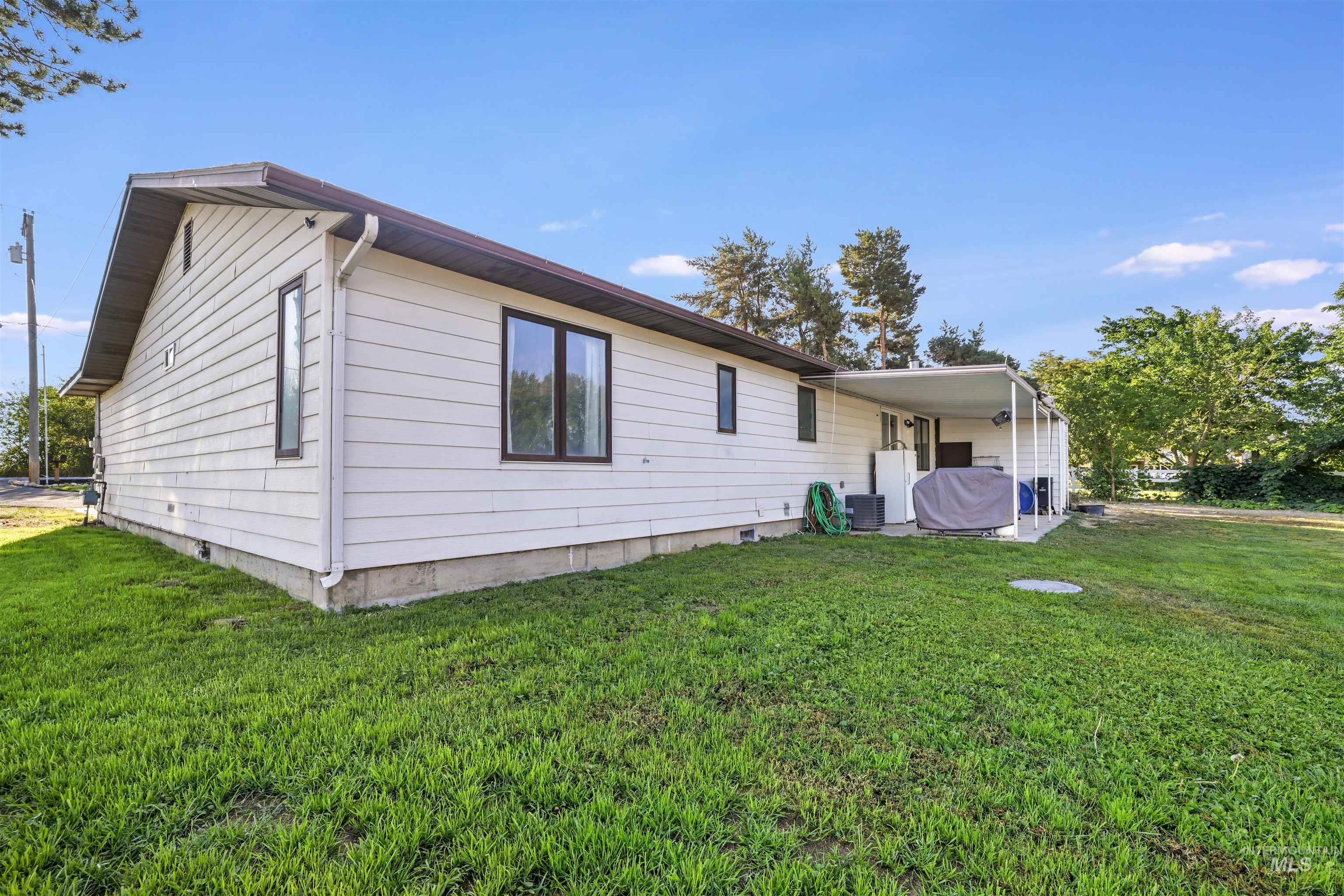 Rear view of property featuring a yard and crawl space