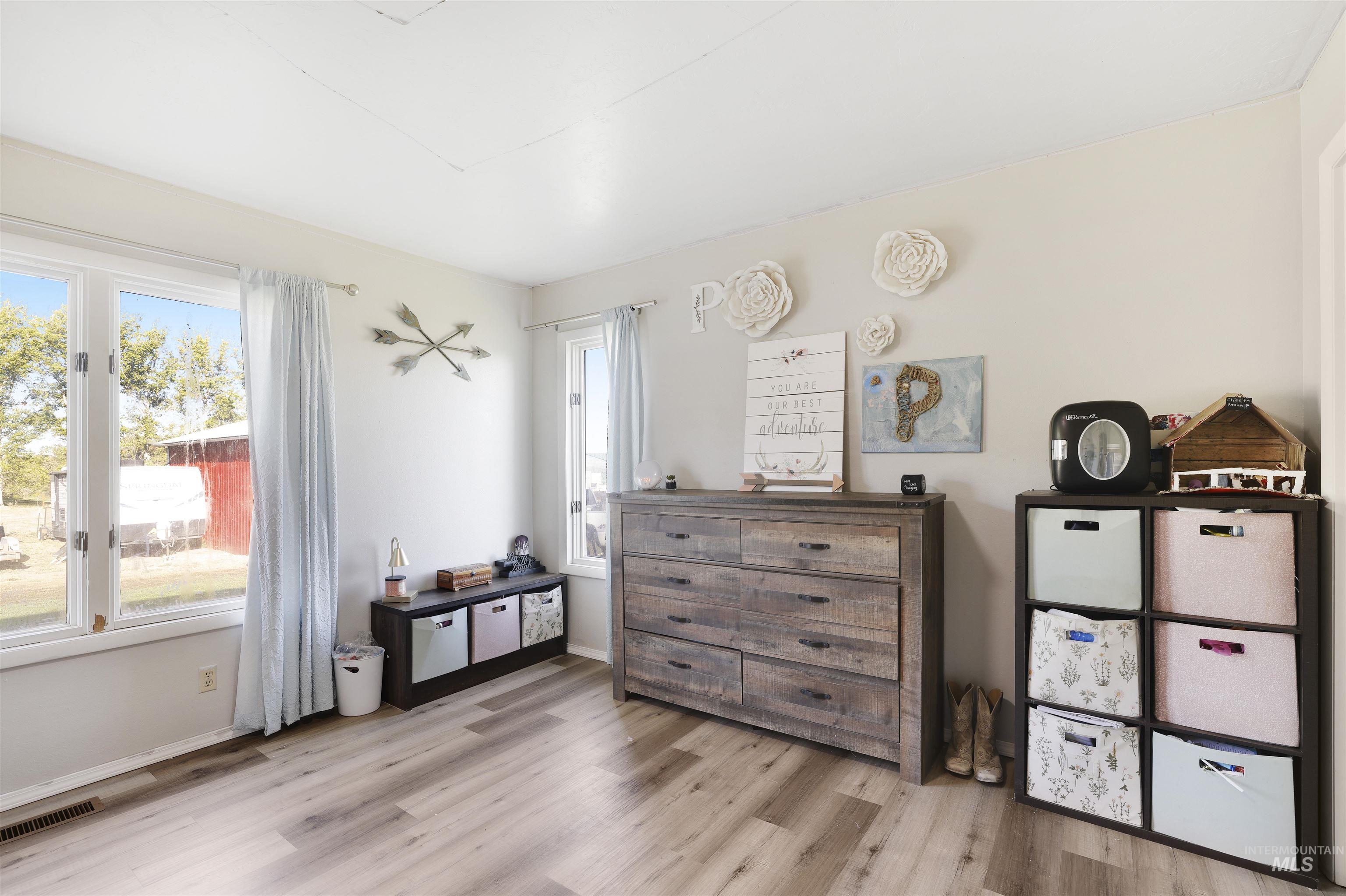 Living area featuring light wood-style floors and baseboards
