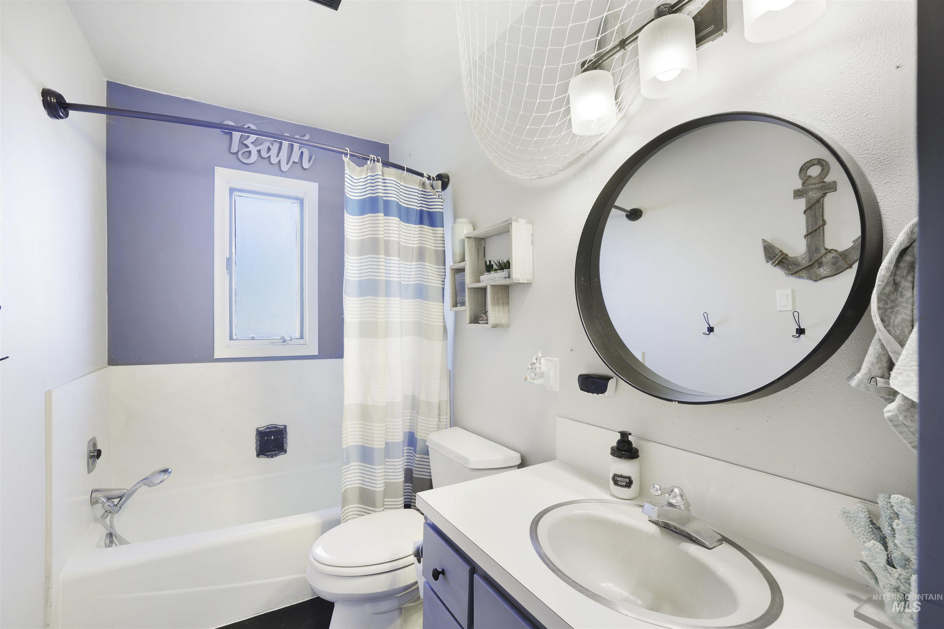 Full bathroom with vanity and shower / tub combo