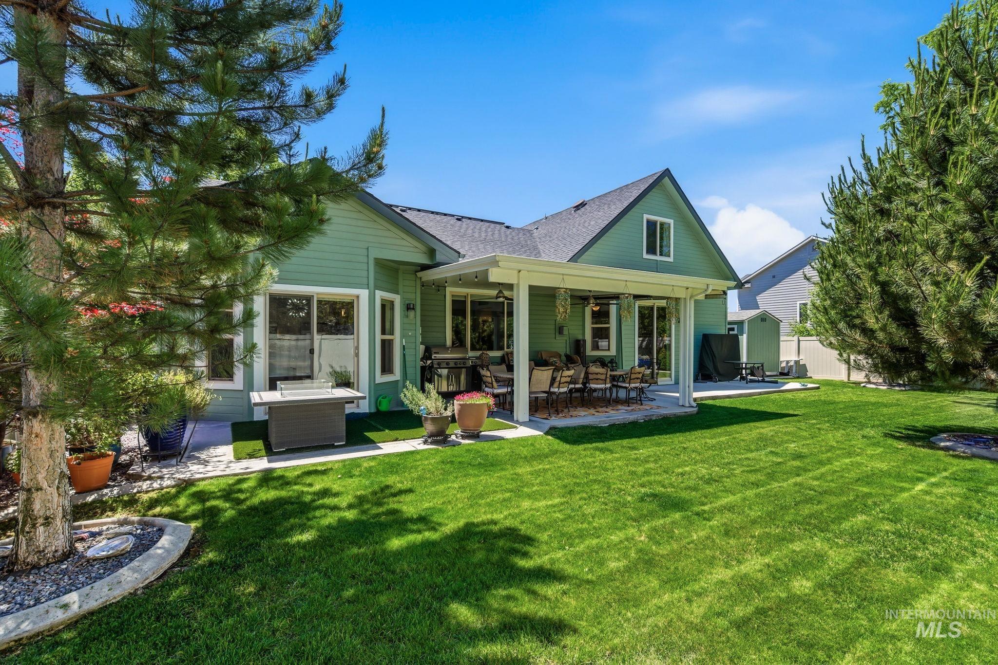 Expansive green lawn with a covered patio area