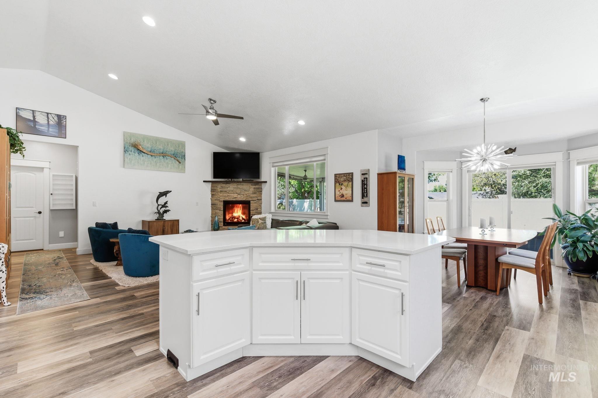 Open-concept interior featuring a central island with white cabinetry and a light-colored countertop