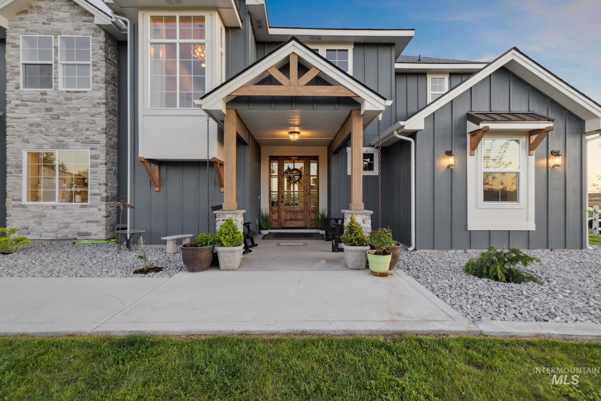 Entrance to property with board and batten siding and stone siding
