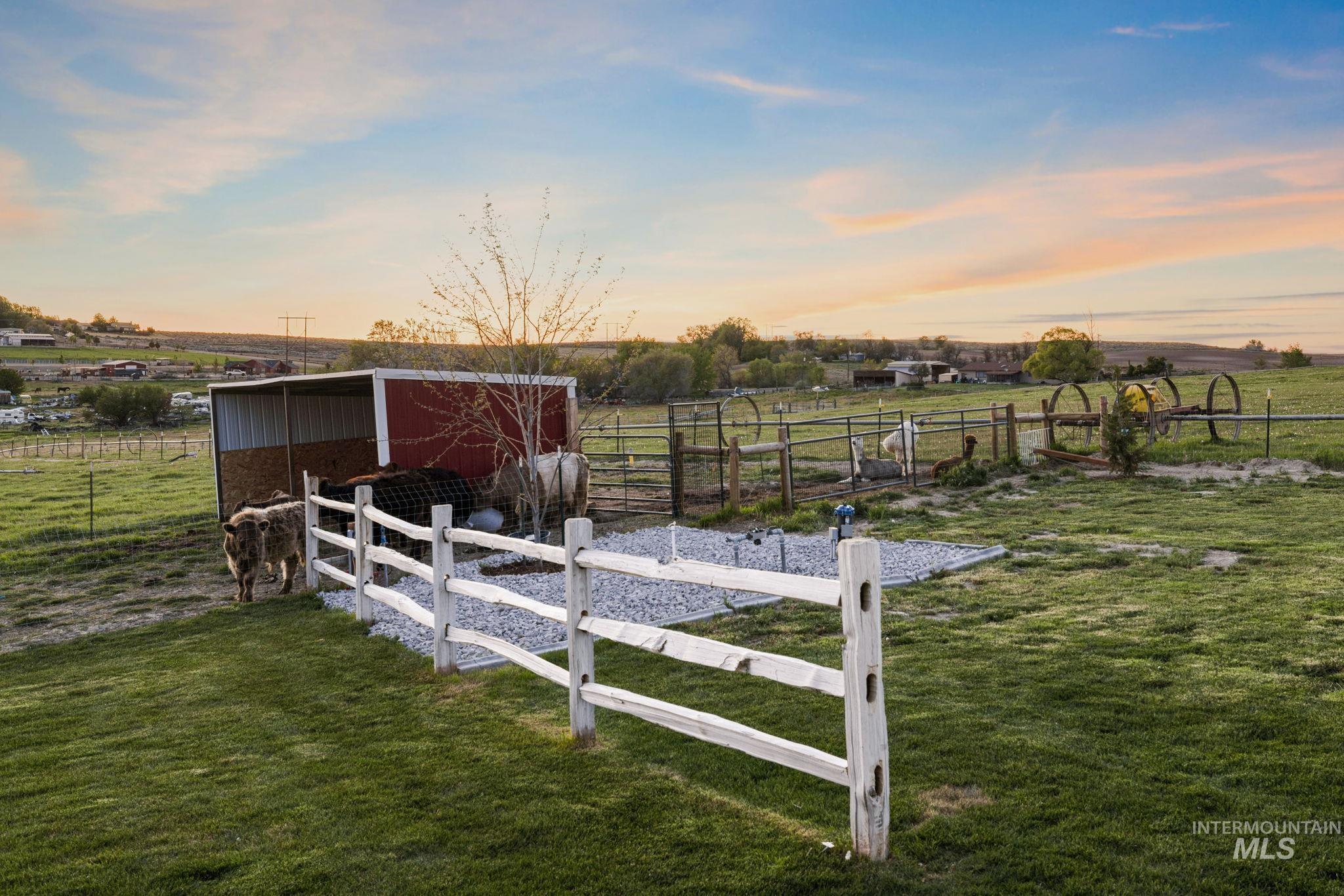 View of yard with a view of rural / pastoral area, an outbuilding, and an exterior structure
