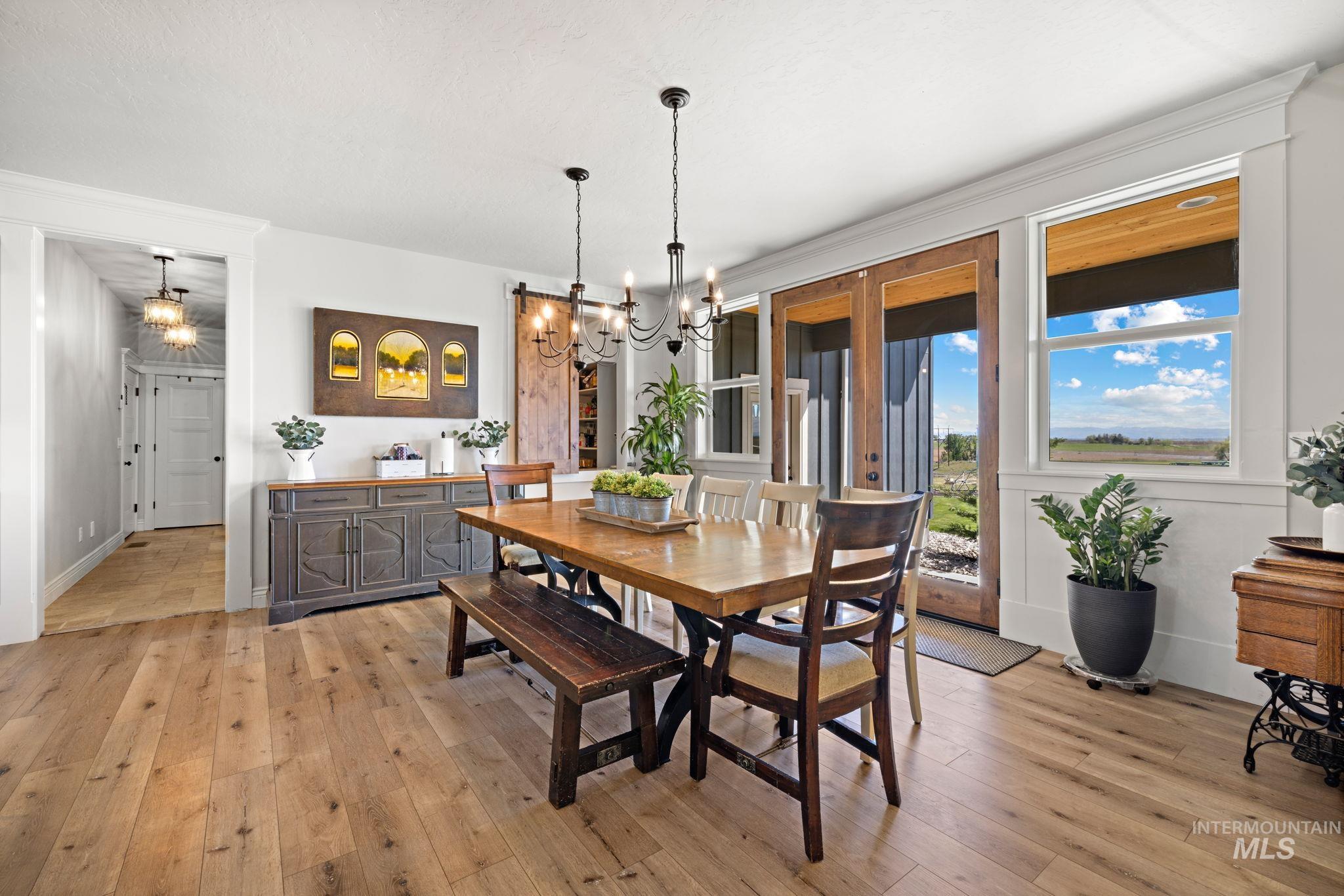 Dining room featuring a chandelier, light wood-style floors, and crown molding