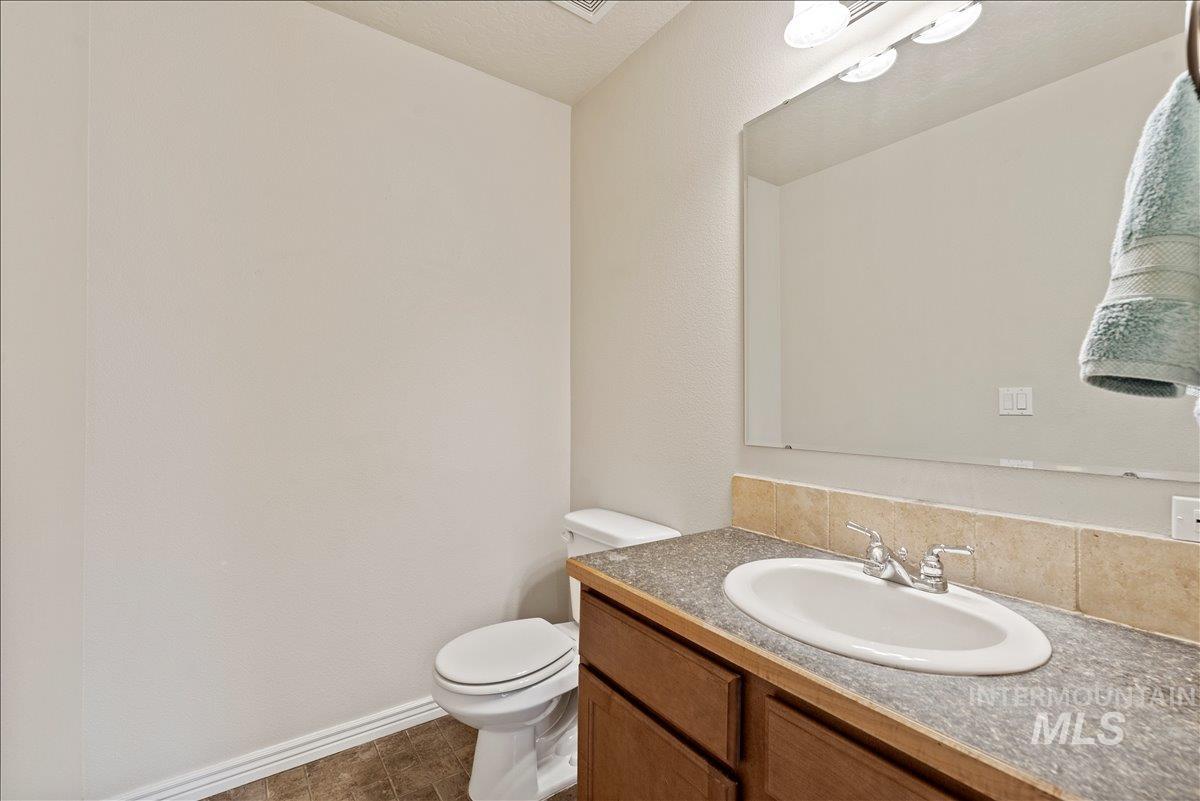 Bathroom with vanity and dark tile patterned floors