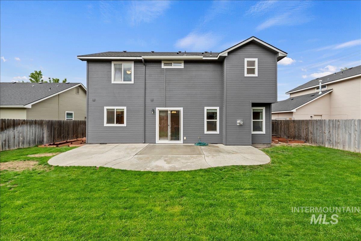 Rear view of property featuring a patio area and a fenced backyard