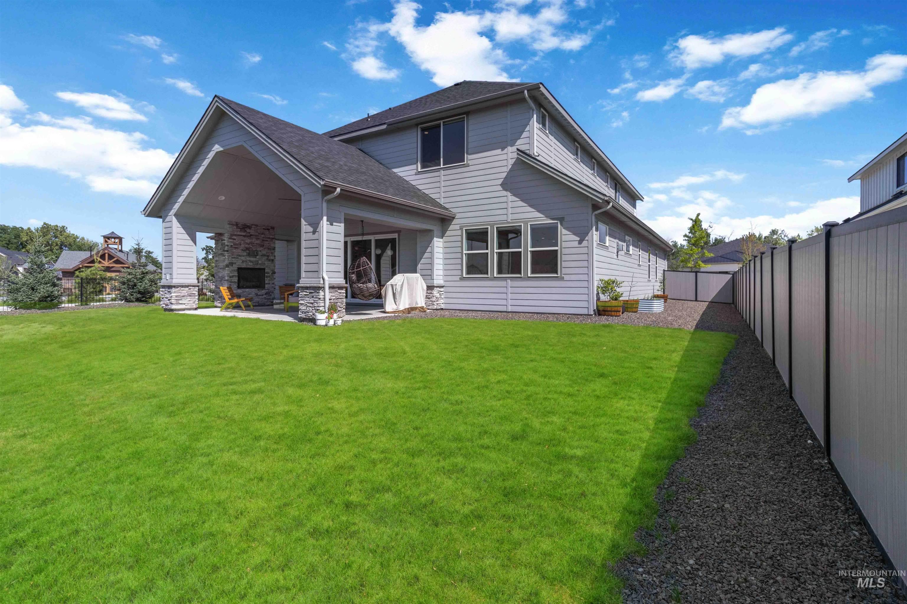 Back of property featuring a fenced backyard and a patio area