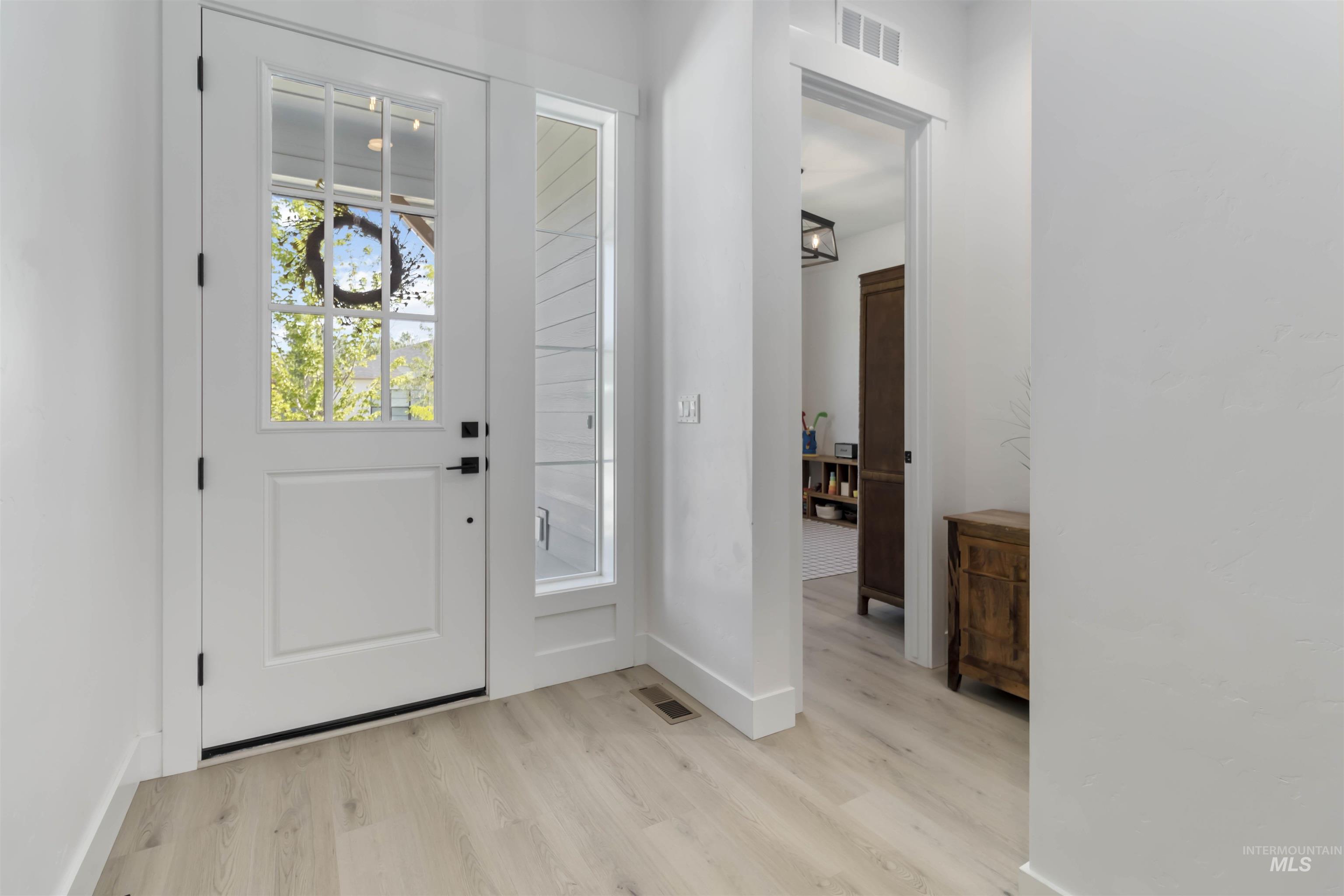 Entryway featuring light wood-style floors and baseboards