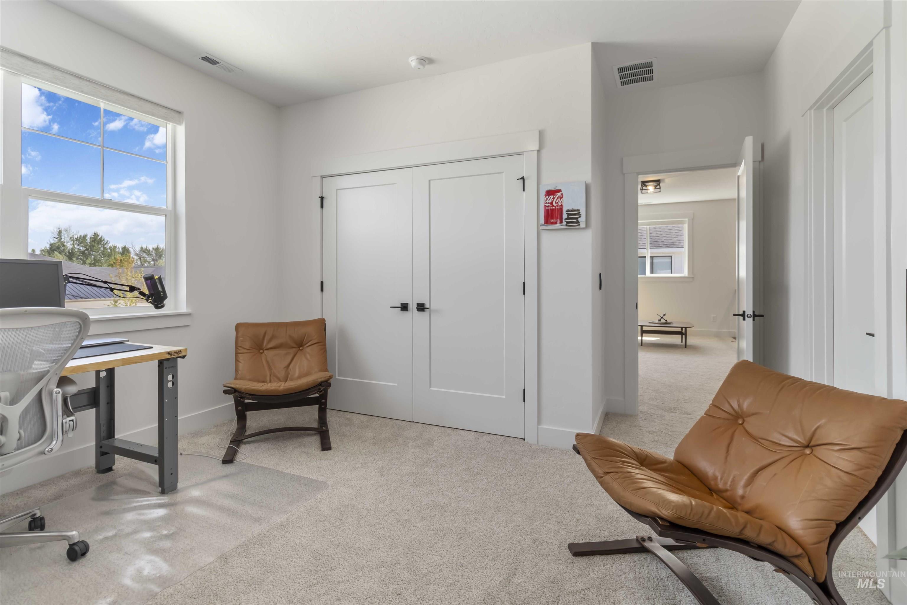 Home office with light carpet