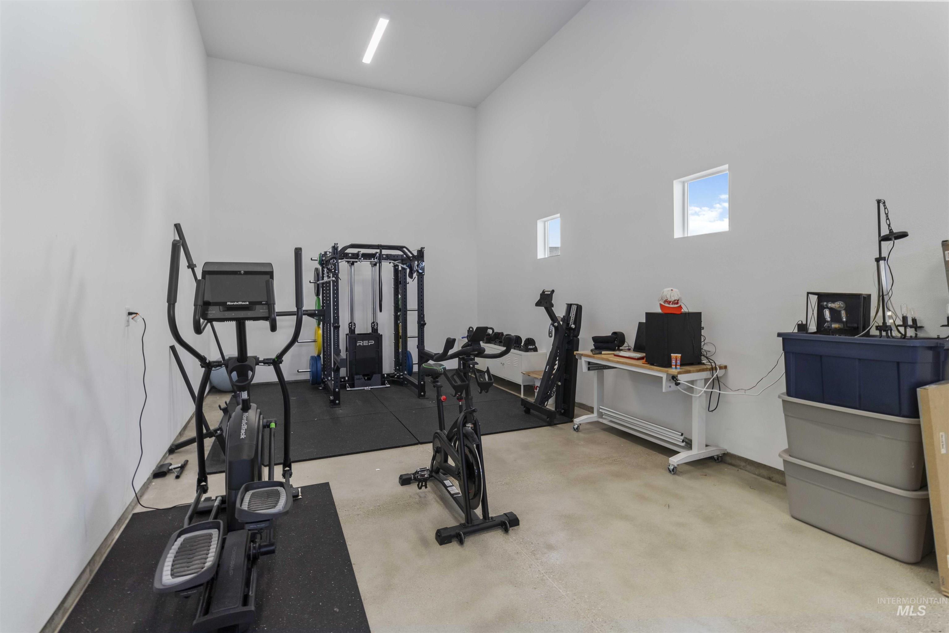 Exercise room featuring a high ceiling
