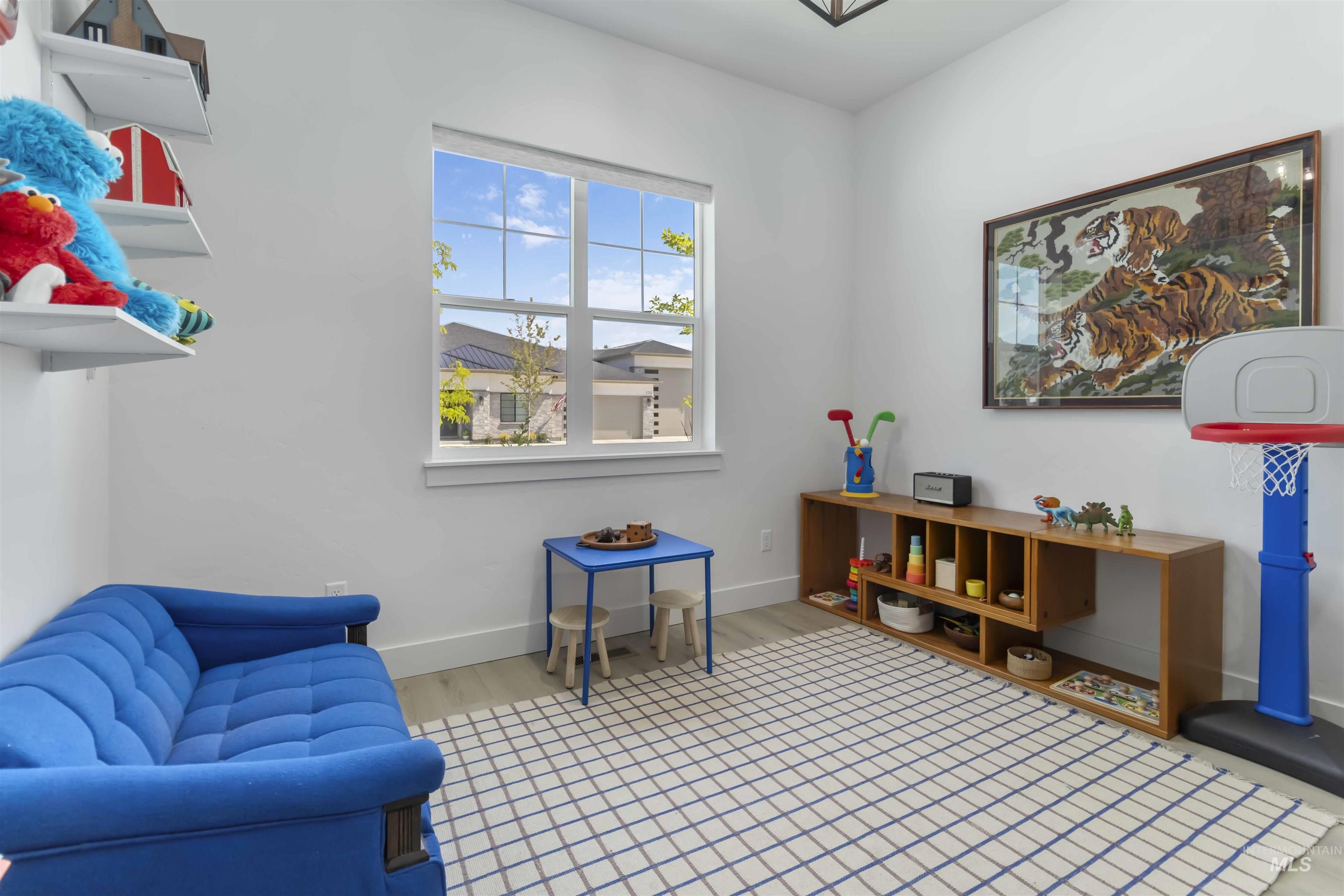 Living area with light wood-style floors and baseboards