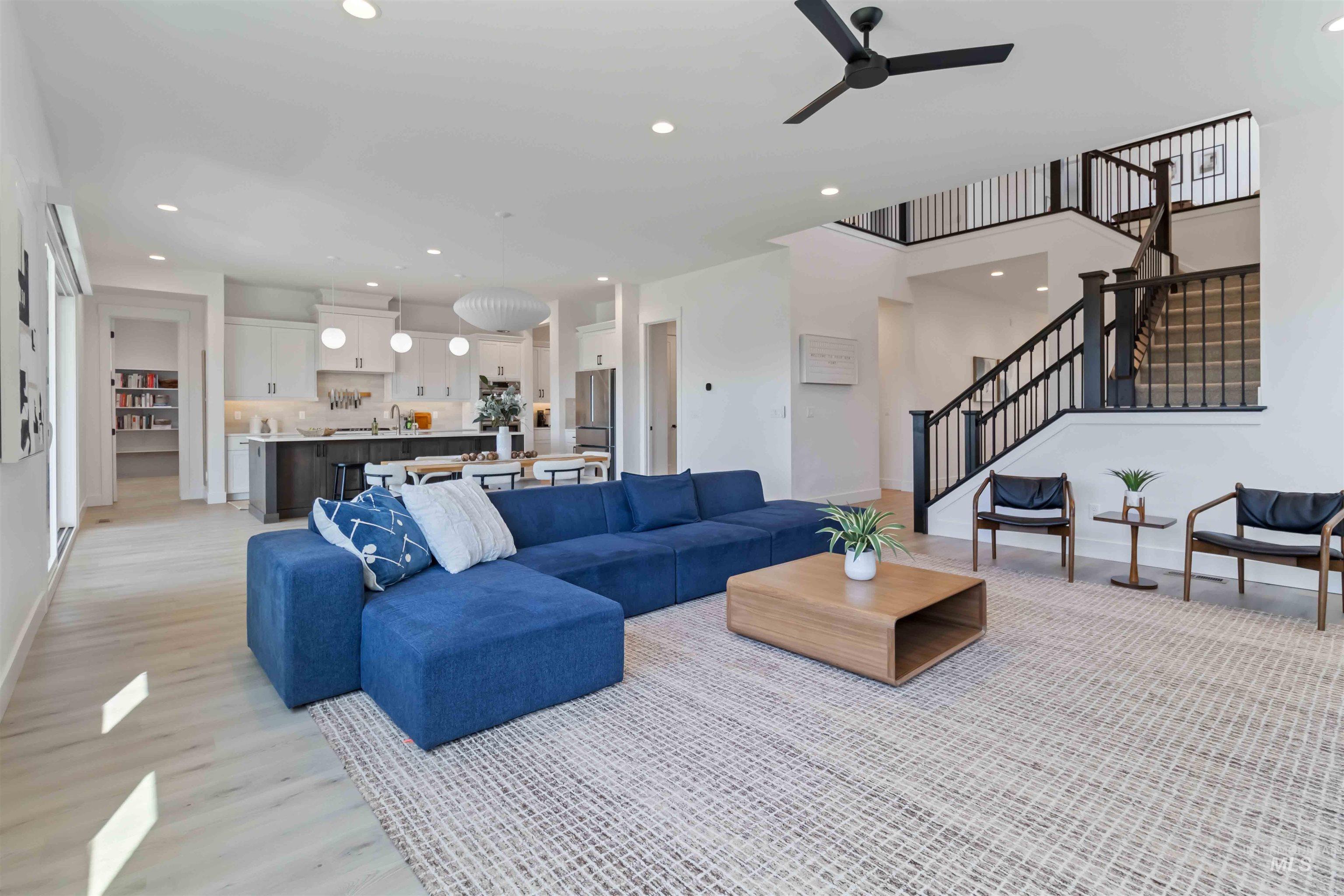 Living area with recessed lighting, a ceiling fan, and light wood-style flooring