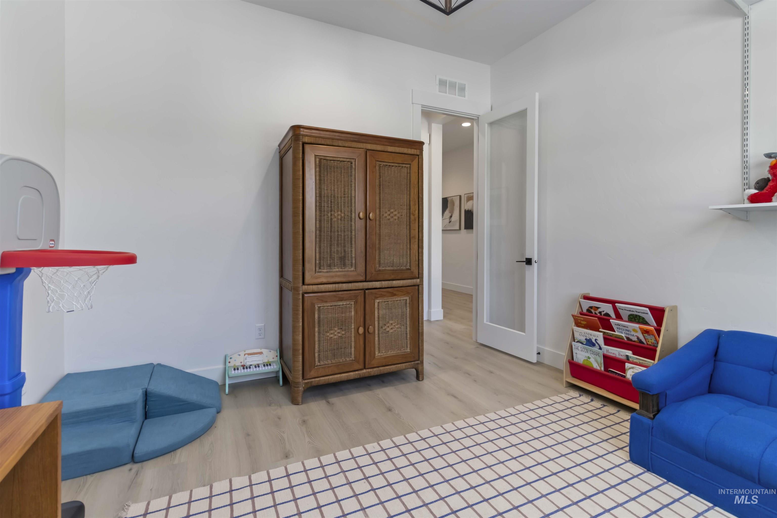 Sitting room with light wood-type flooring and baseboards