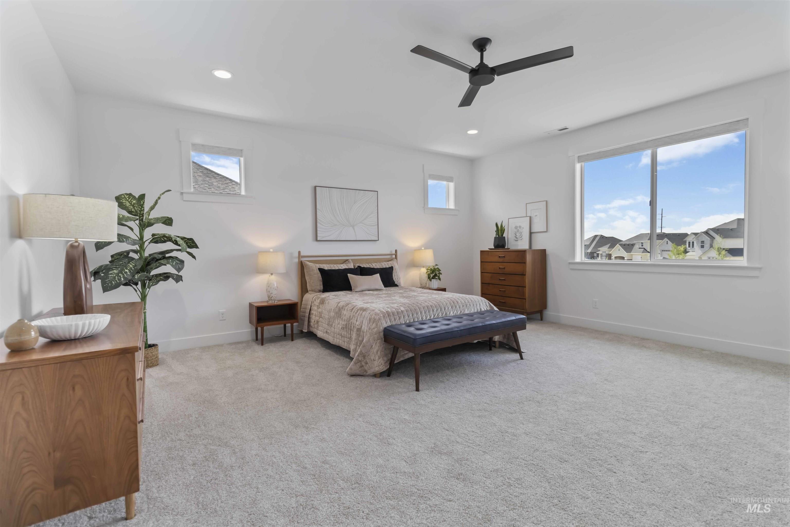 Bedroom featuring light carpet, ceiling fan, recessed lighting, and multiple windows