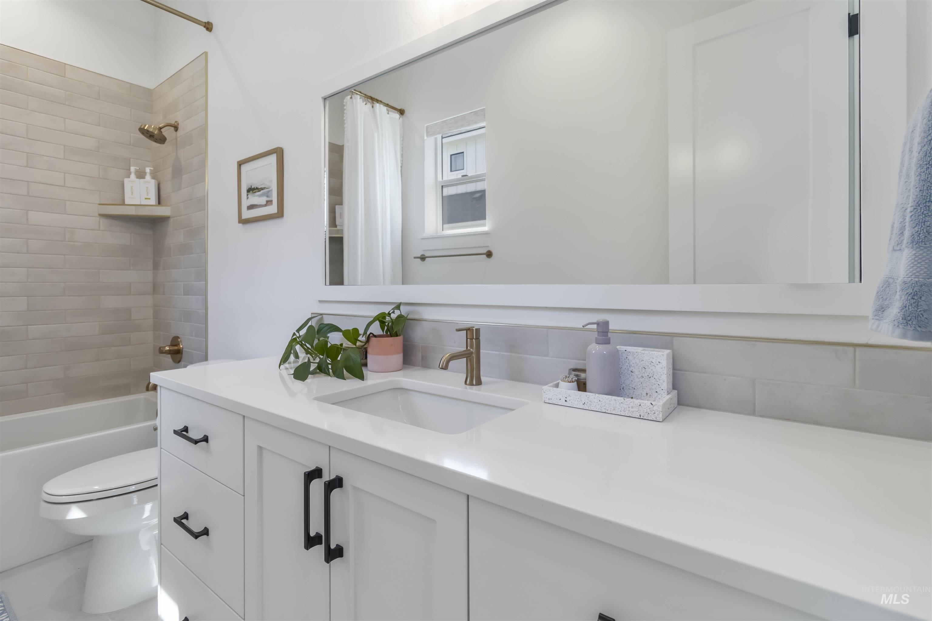 Full bathroom featuring vanity and shower / bath combo with shower curtain
