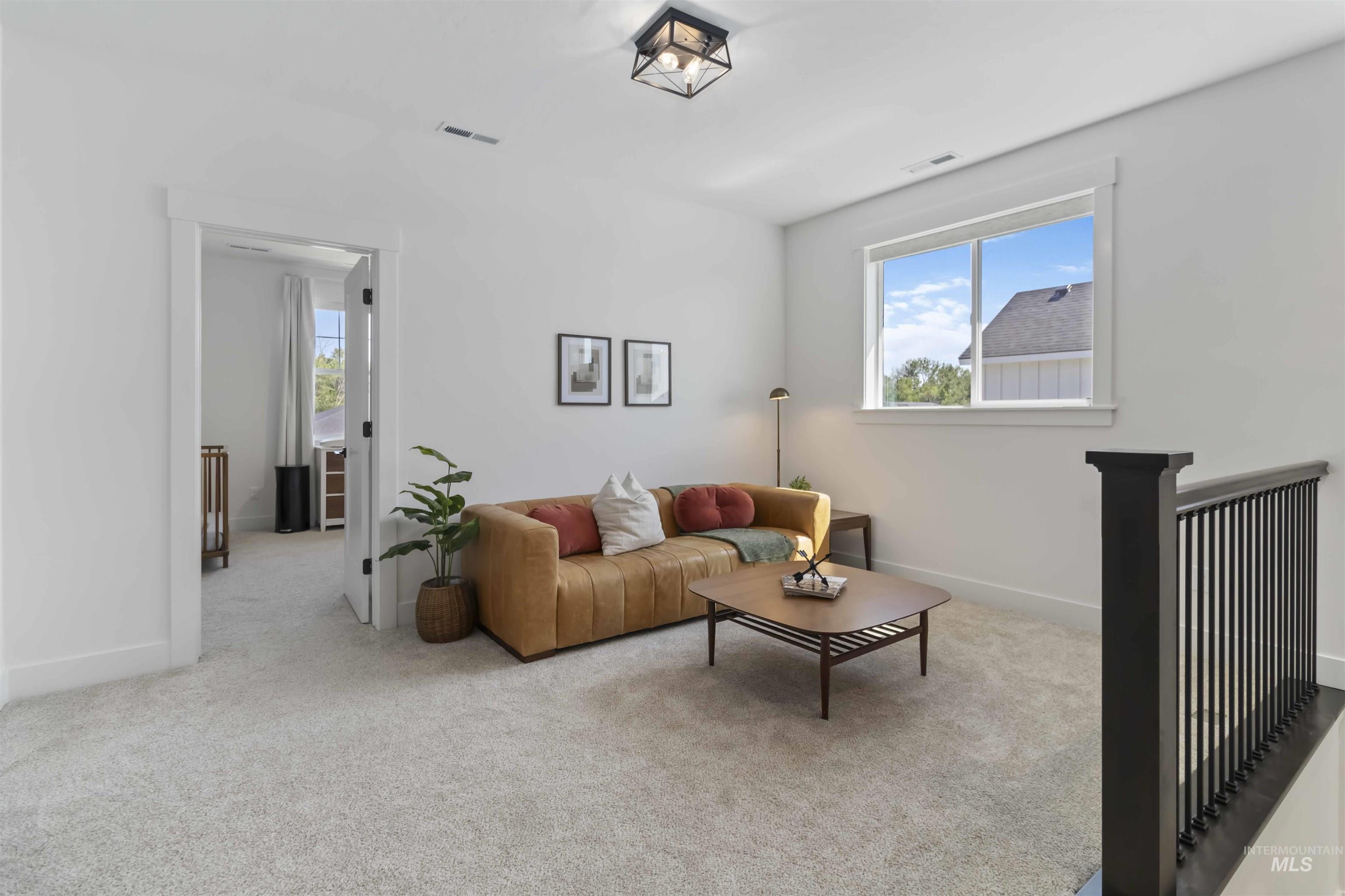 Living room featuring carpet and baseboards