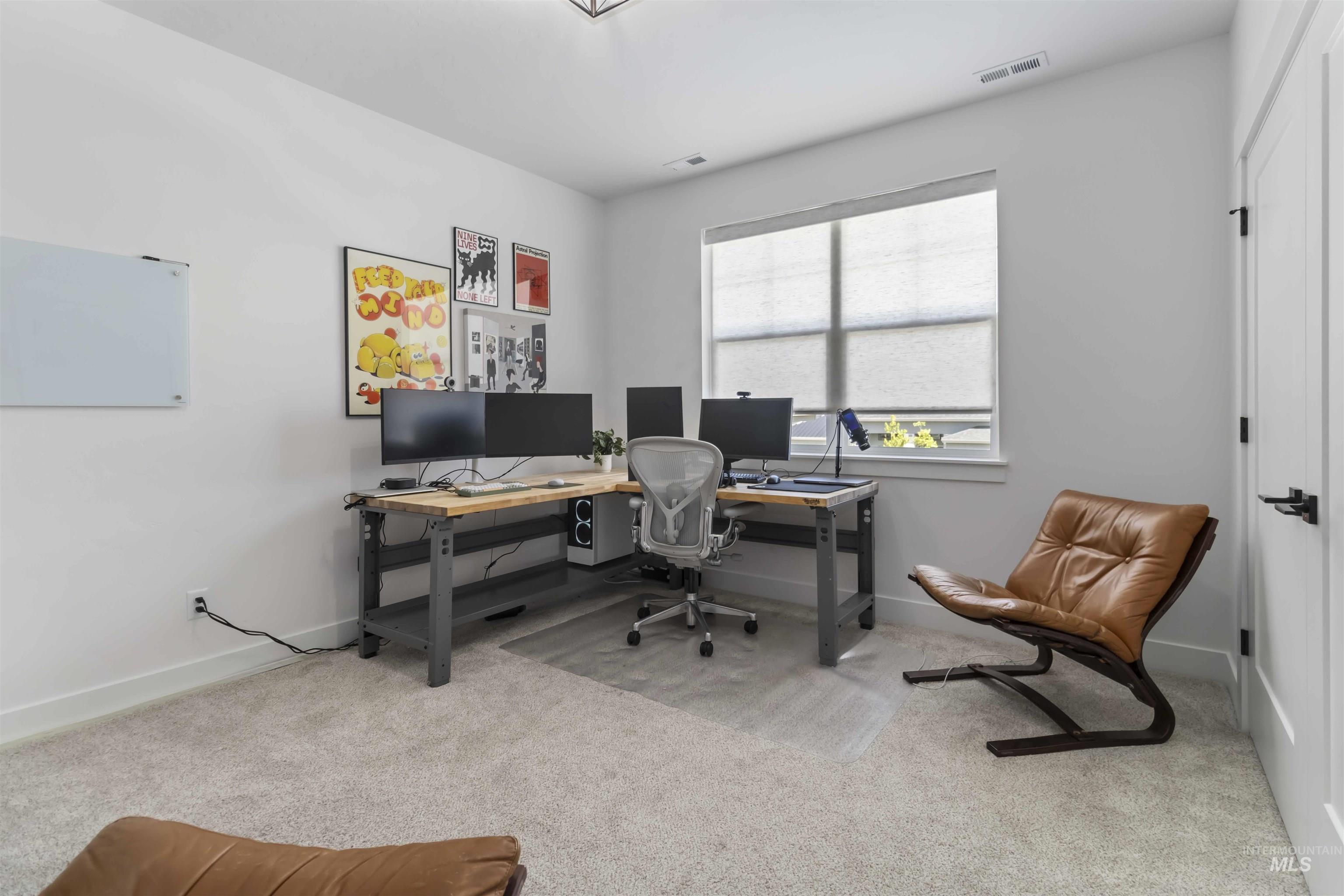 Office with light carpet and baseboards