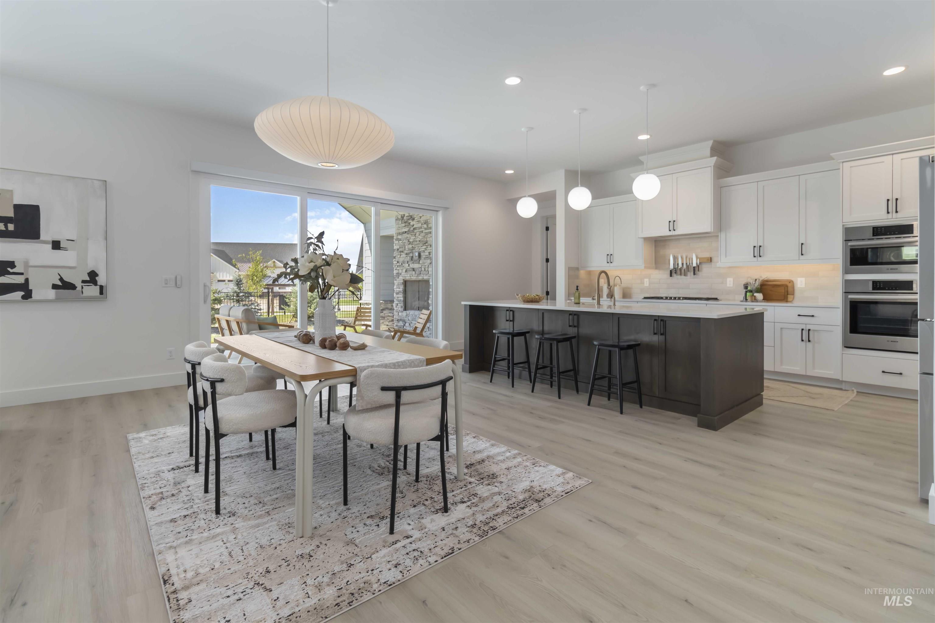 Dining space featuring recessed lighting and light wood-style flooring