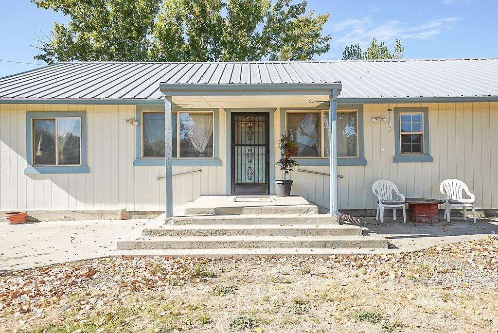 Entrance to property featuring a metal roof