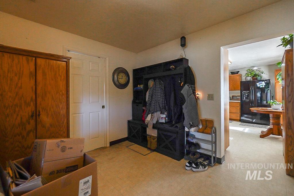 Bedroom featuring black fridge and light flooring