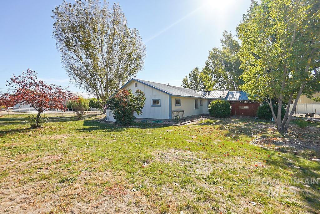 Rear view of house featuring a metal roof