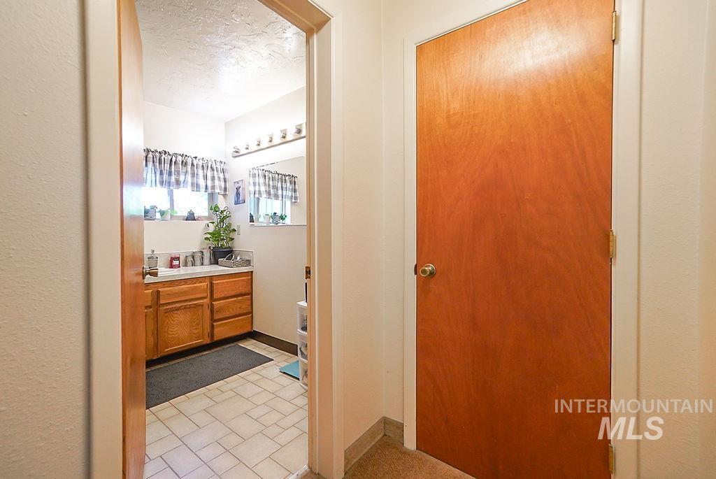 Bathroom featuring vanity, a textured ceiling, and light tile patterned flooring